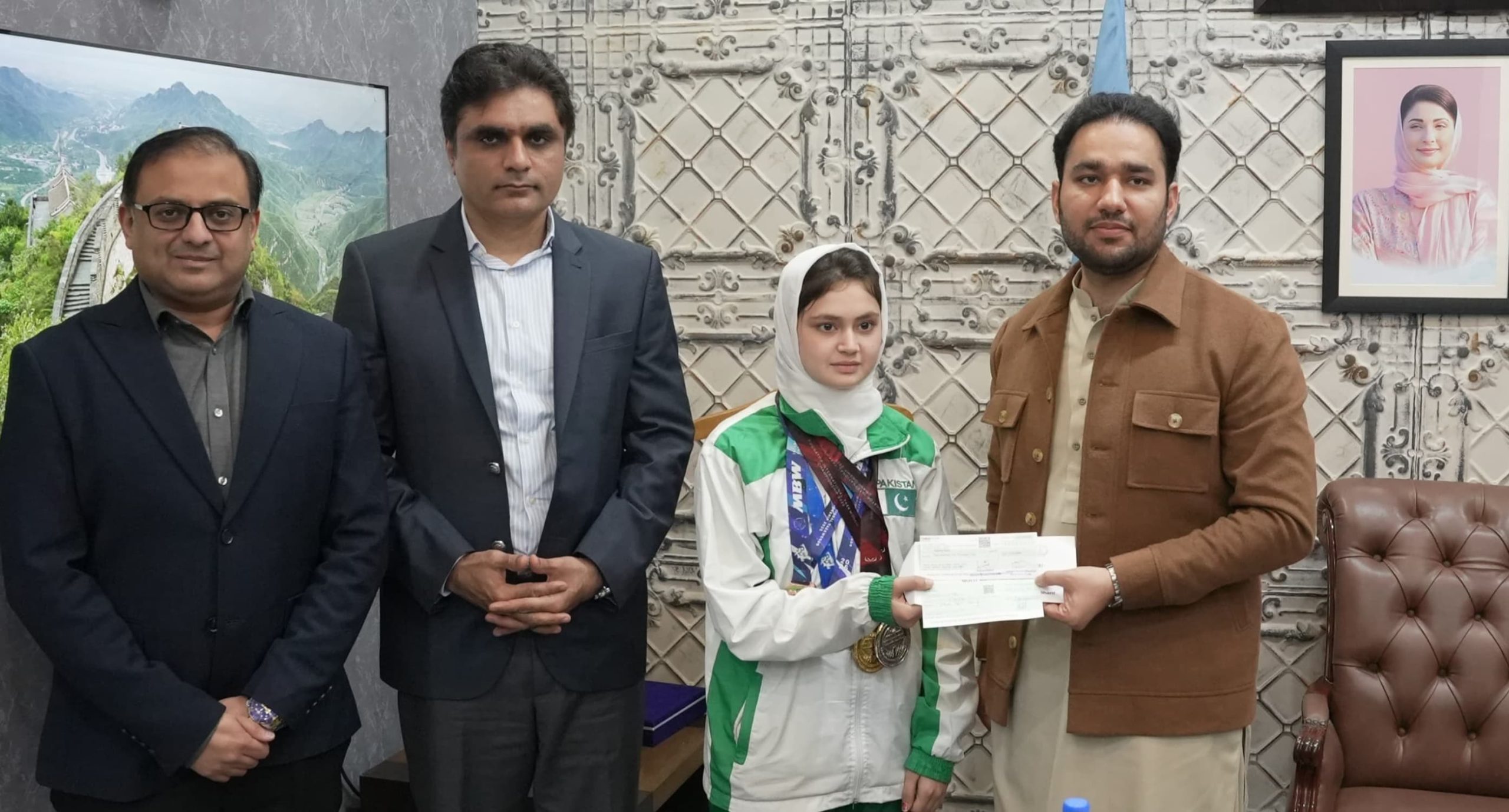 Punjab Minister for Sports presents a cheque of Rs3 lakh to taekwondo star Ayesha Ayaz